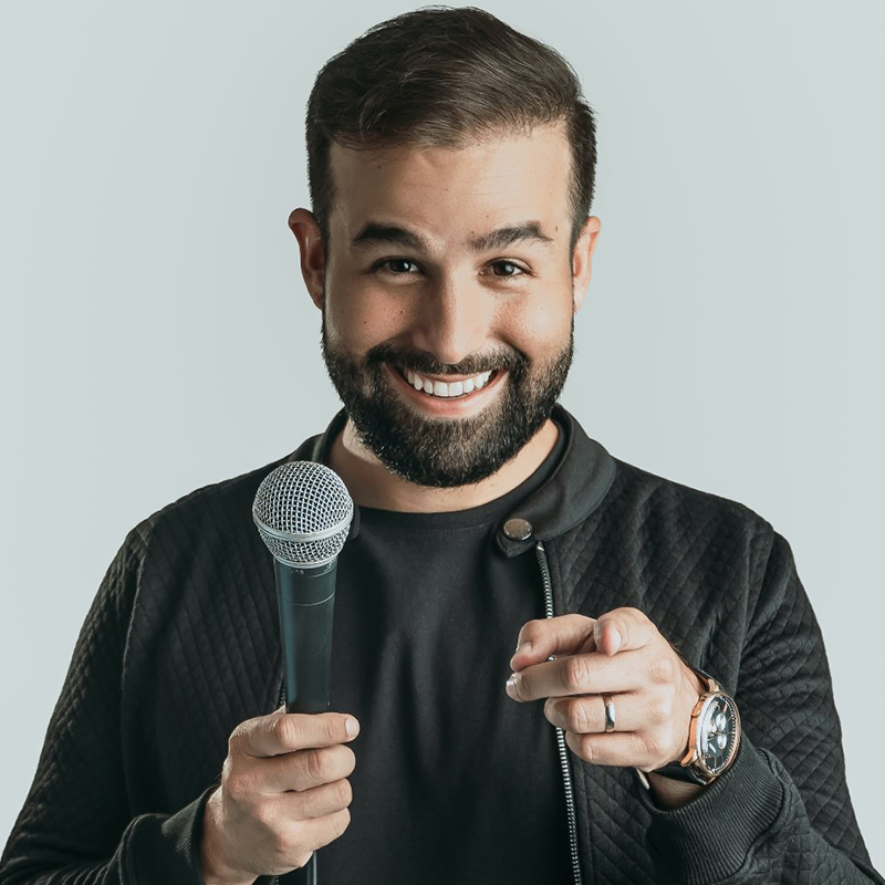 Stephan D. performing on stage as a stand-up comedian.